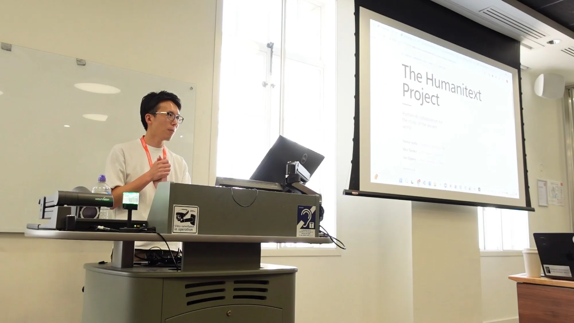 Naoya Iwata opening the panel with "The Humanitext Project" title slide at The Digital Conference 2026